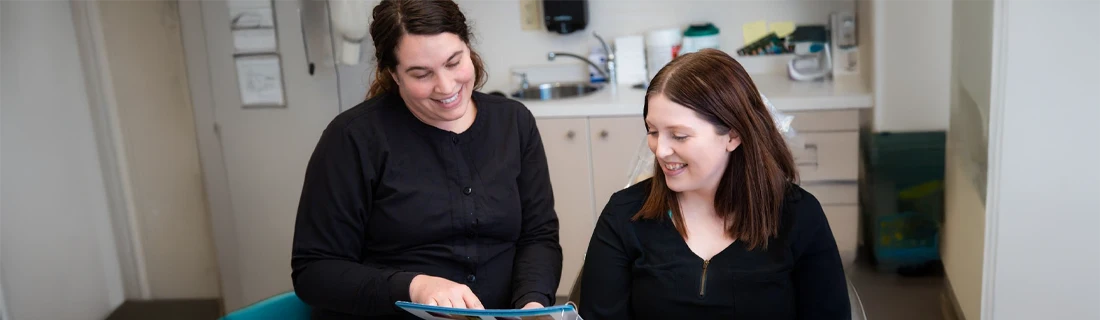 Dentist Lewiston ME Dental Fears dental assistant goes over x-rays with patient in consultation