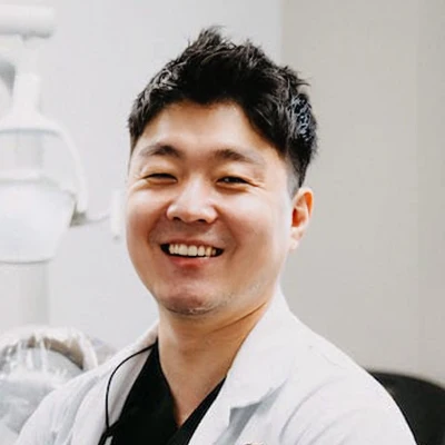 Dentist at Aspire Family Dentistry, Sang Joon Lee, is seen smiling warmly at the viewer